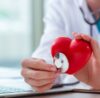 Cardiologist reviewing a patient’s heart screening results with a stethoscope and ECG monitor, symbolizing early detection and preventive heart care.