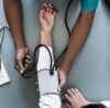 Doctor measuring a patient’s blood pressure during a routine heart health check-up, emphasizing hypertension monitoring.
