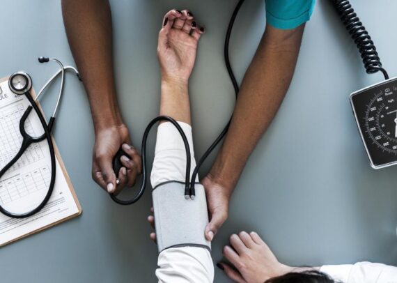 Doctor measuring a patient’s blood pressure during a routine heart health check-up, emphasizing hypertension monitoring.
