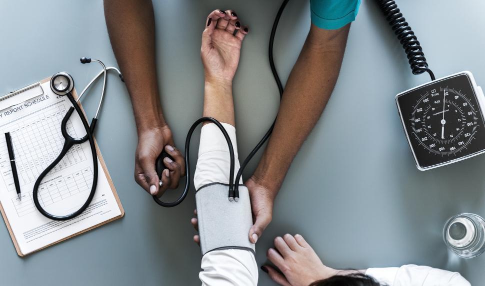 Doctor measuring a patient’s blood pressure during a routine heart health check-up, emphasizing hypertension monitoring.