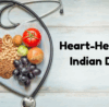 Heart-shaped plate filled with Indian whole grains, legumes, nuts, fruits, and vegetables, placed next to a stethoscope, representing a balanced Indian diet for heart health as recommended by Dr. Akshay Kashid.