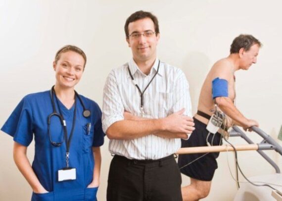 Patient walking on treadmill during TMT stress test with ECG monitoring