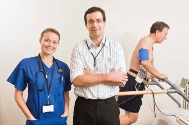 Patient walking on treadmill during TMT stress test with ECG monitoring