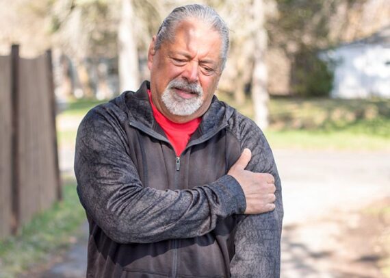 Man experiencing left arm pain and chest discomfort related to possible heart symptoms